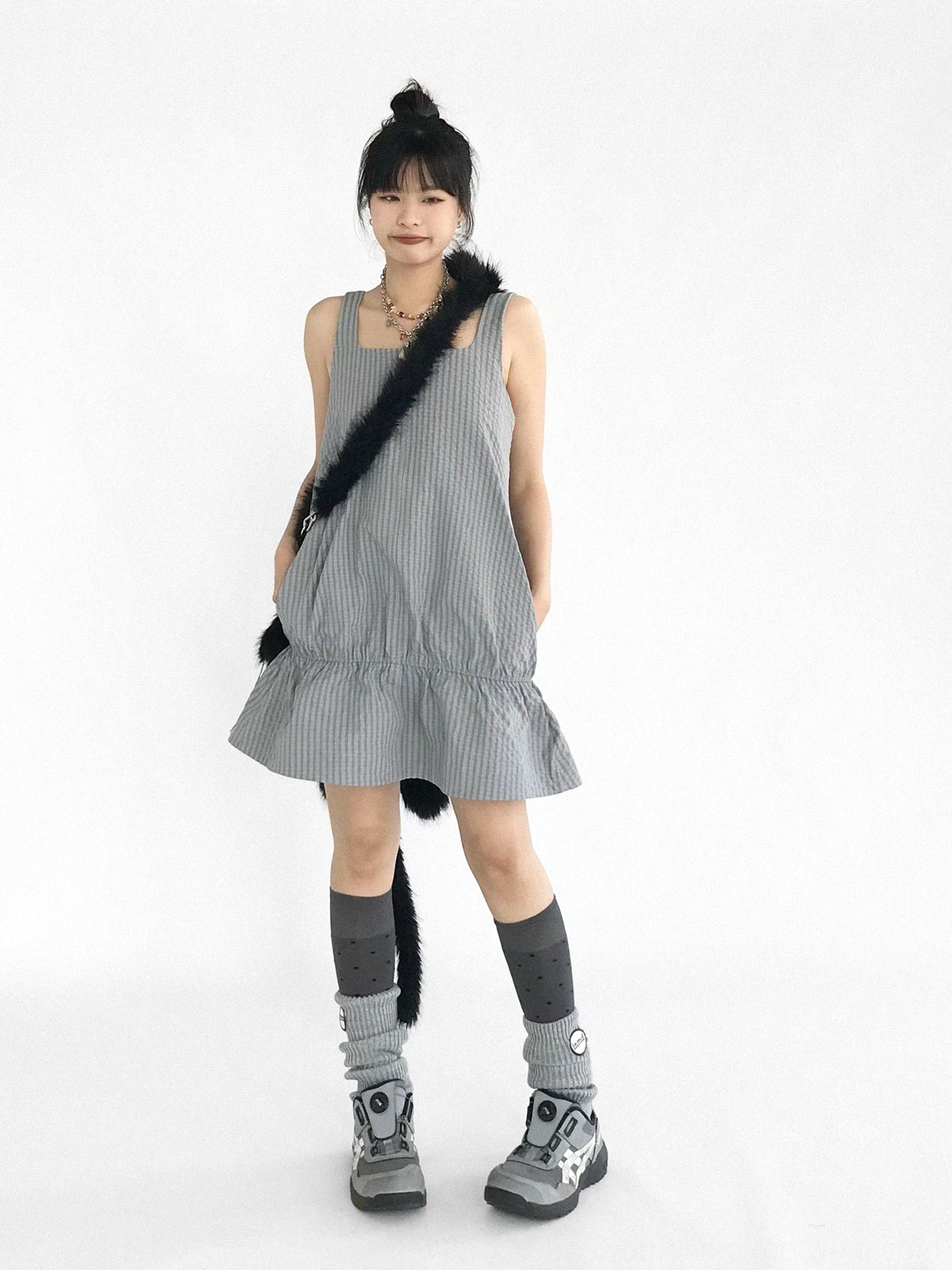 Gray gingham ruffled pinafore mini dress front view with square neckline wide straps and flared hem
