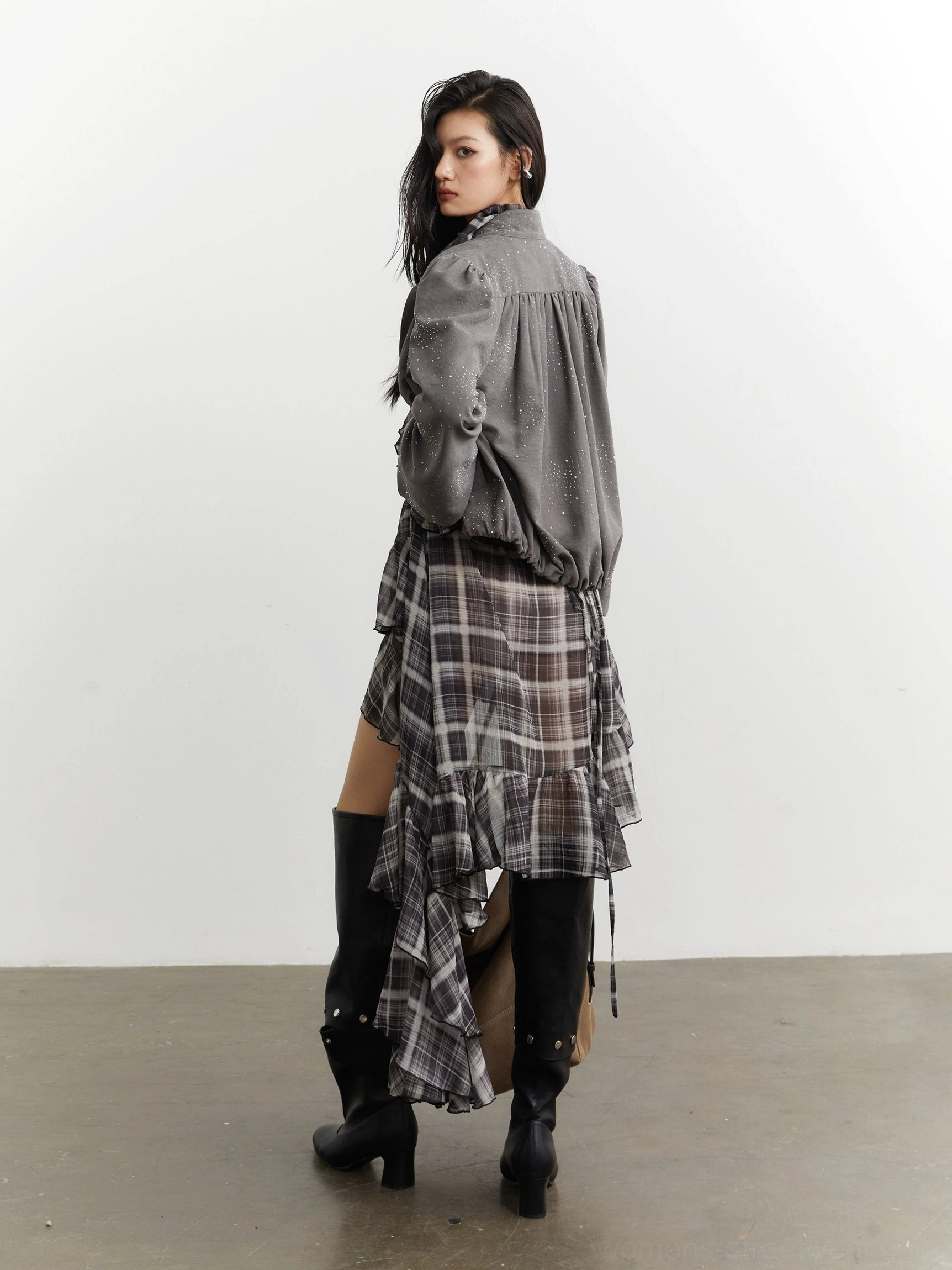Back view of gray glitter cropped streetwear jacket showing gathered back seam detailing elasticated hem and voluminous bishop sleeves