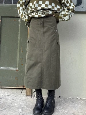 Gray-green high-waist drawstring cargo maxi skirt front view styled with checkerboard cropped hoodie and platform boots