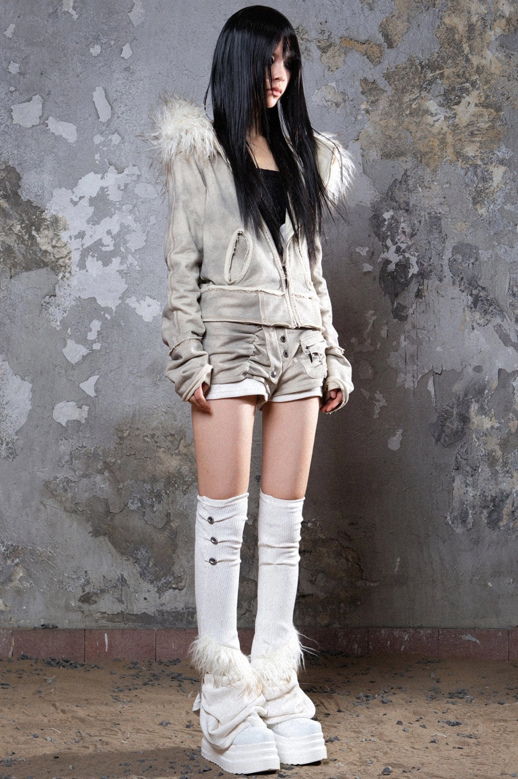 Gray hooded streetwear jacket with soft faux fur trim, practical pockets, and relaxed cold-weather layering silhouette
