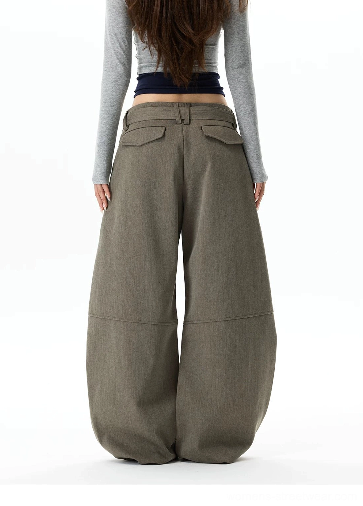 Full rear view of gray khaki balloon leg trousers showing curved oversized silhouette, rear patch pockets, and clean streetwear styling
