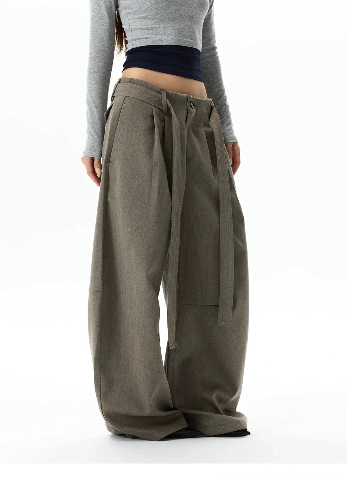 Side front view of gray khaki ultra-wide leg streetwear trousers showing precise side seams, oversized volume, and a floor-grazing hem