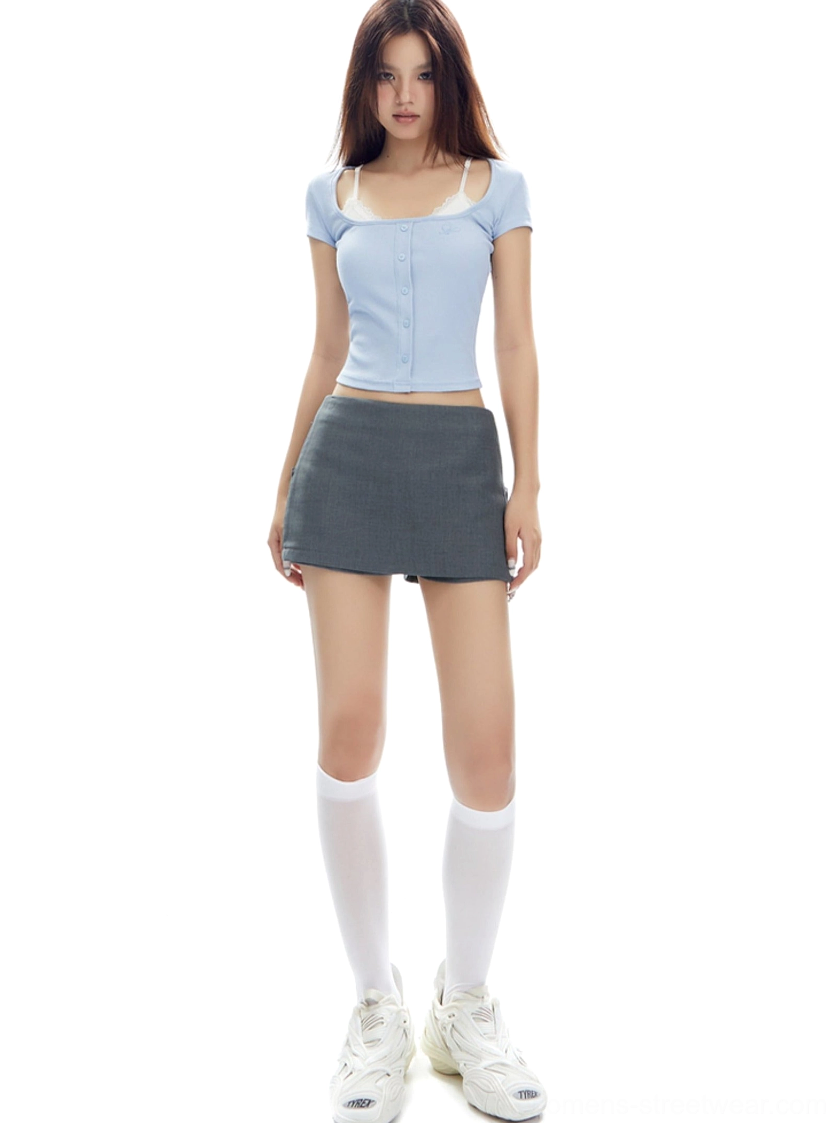 Full-body streetwear outfit featuring a simple gray low-rise mini skirt, cropped blue top, white socks, and sneakers