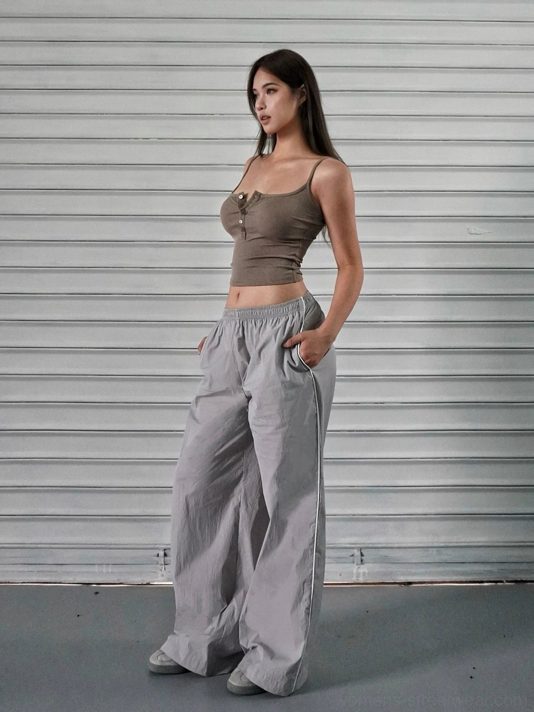 Gray low-rise wide-leg cotton linen cargo pants styled with a brown cropped camisole and side pockets