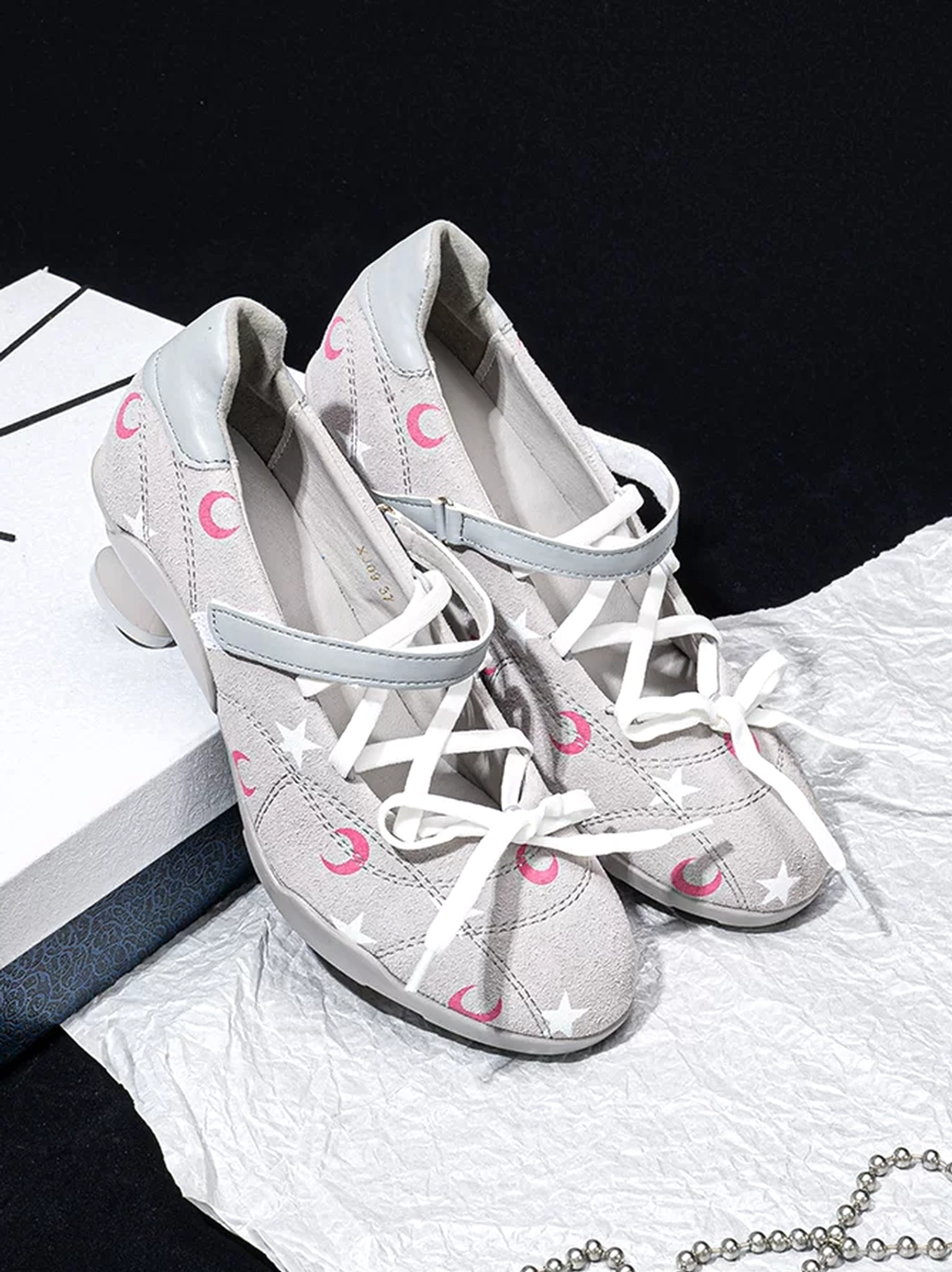 Gray moon print low-heel sport Mary Janes side angled view with lace-up front and curved heel