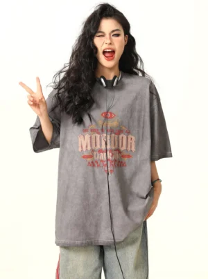 Faded gray MORDOR oversized graphic T-shirt styled with headphones and a playful peace sign pose for a relaxed Korean streetwear look
