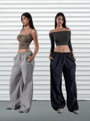 Two models wearing gray and navy blue low-rise wide-leg streetwear cargo pants with cropped camisole tops