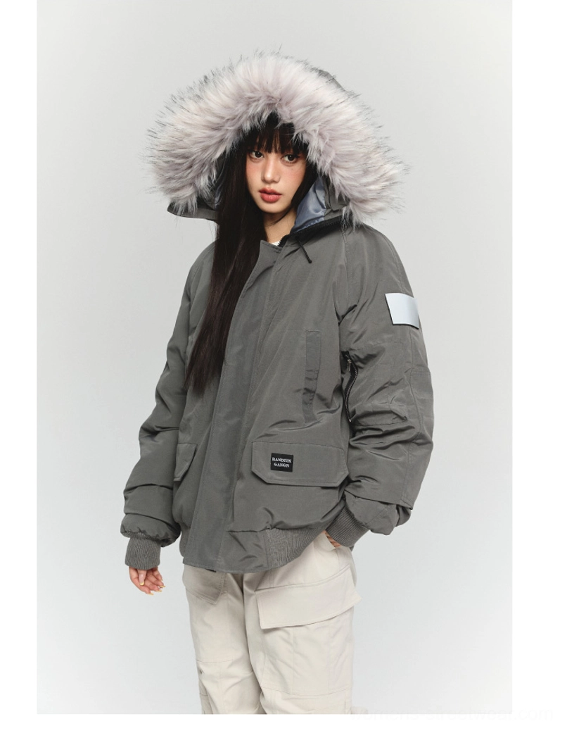 Rear three-quarter view of a relaxed oversized gray faux fur hooded workwear parka styled with beige cargo pants for gorpcore fashion