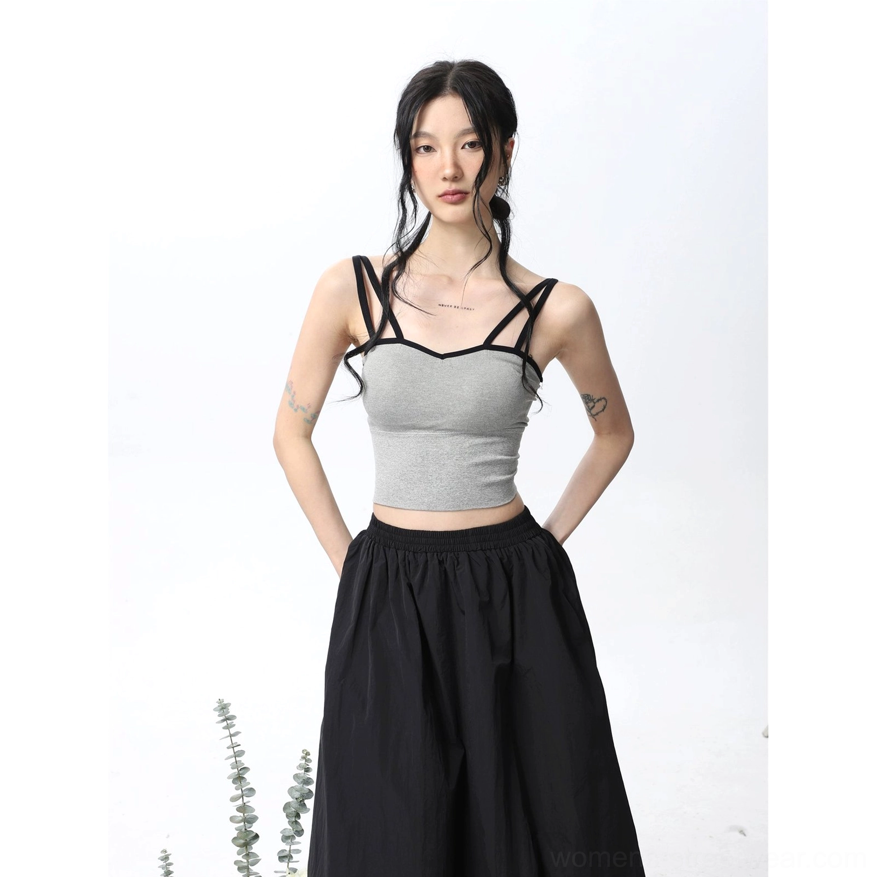 Light gray padded double spaghetti strap cropped camisole tank top with contrasting black straps styled with a flowing black maxi skirt