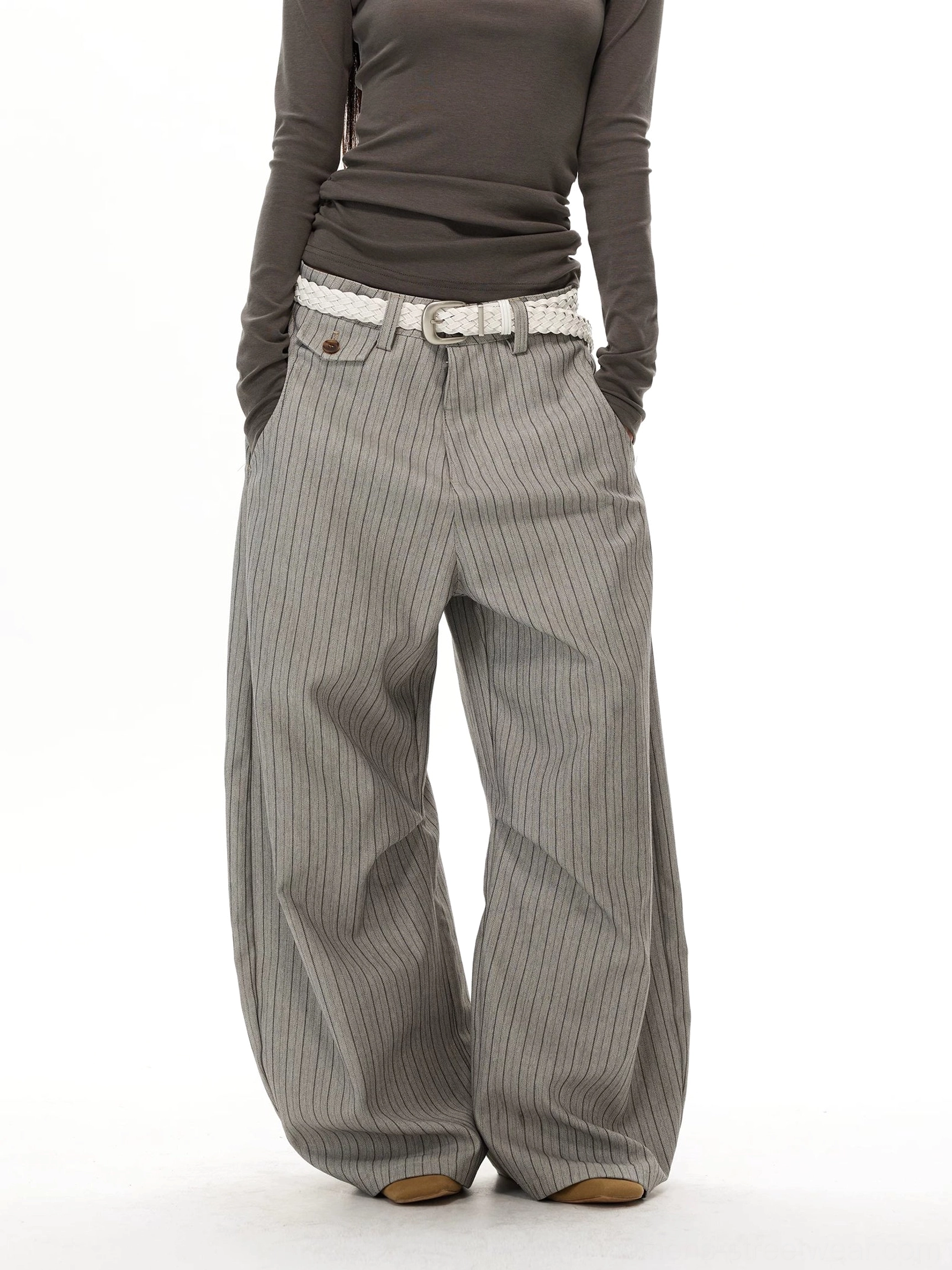 Gray pinstripe super baggy wide-leg trousers front view with hands in pockets and relaxed streetwear fit