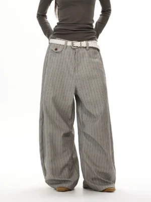 Gray pinstripe super wide-leg streetwear trousers front view with oversized draped silhouette and buttoned coin pocket