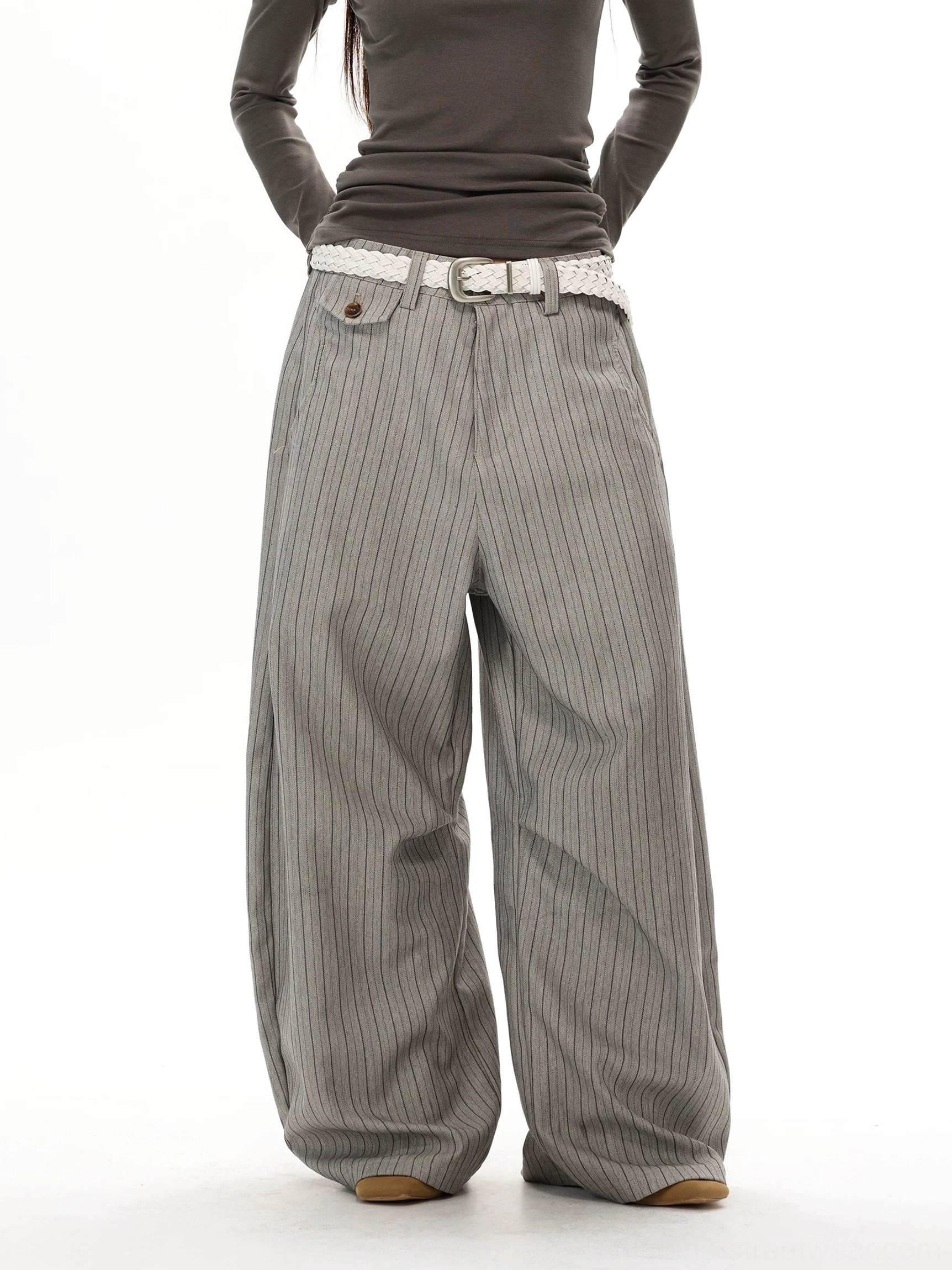 Gray pinstripe super wide-leg streetwear trousers front view with oversized draped silhouette and buttoned coin pocket