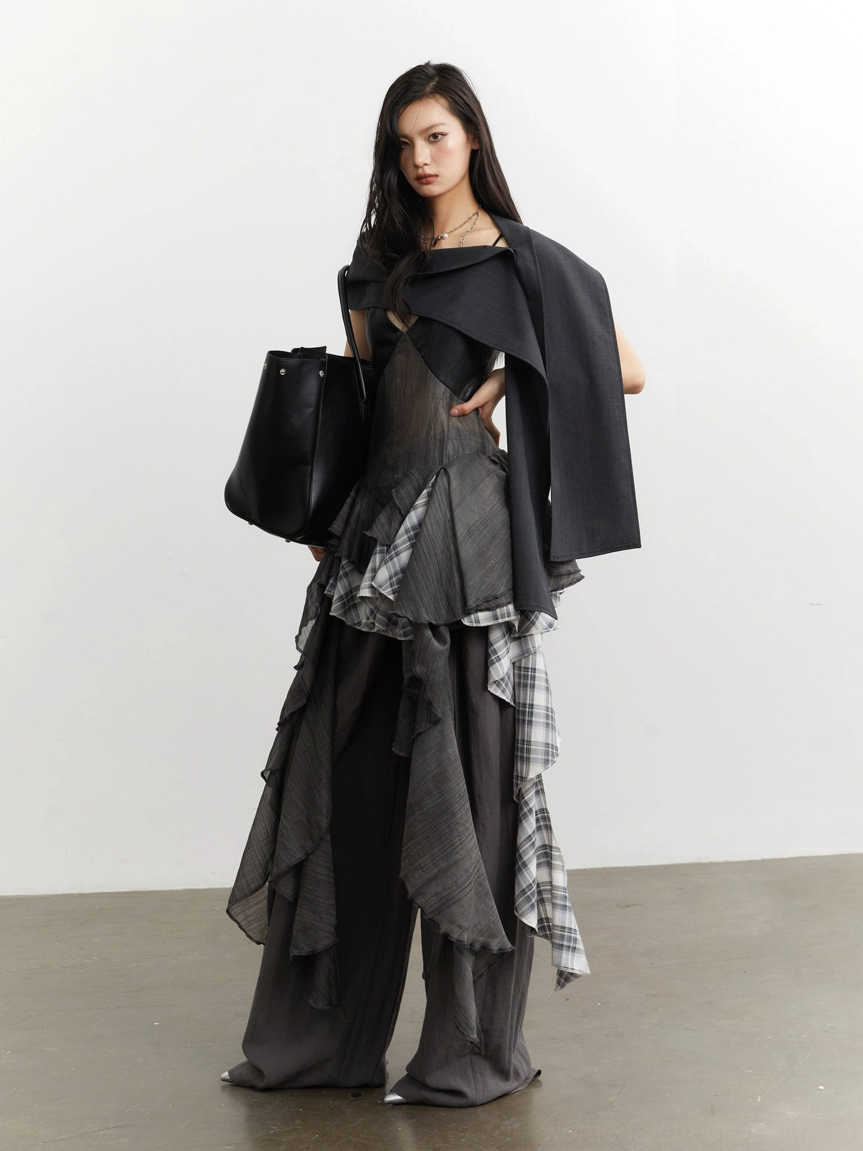 Three quarter side view of gray plaid ruffle sheer mesh deconstructed camisole top in a dark Seoul streetwear outfit