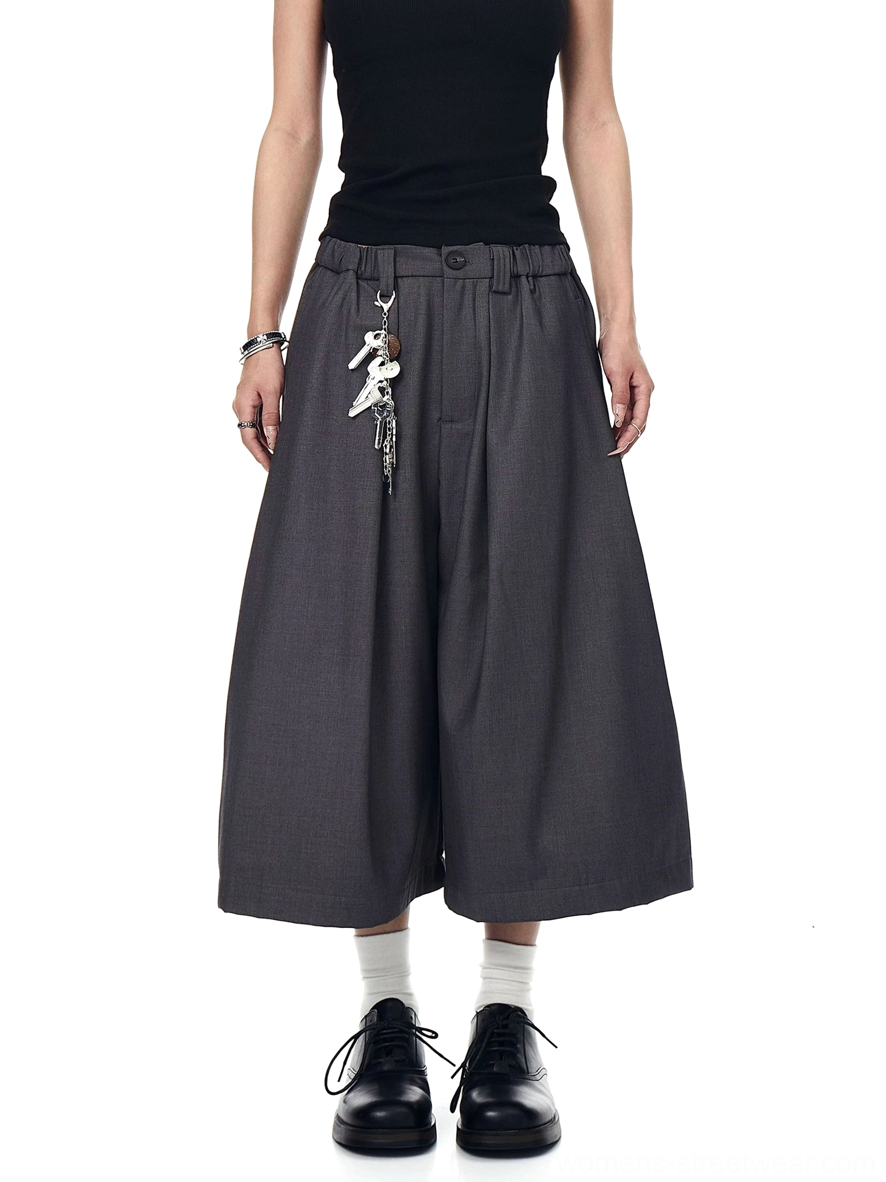 Gray pleated wide-leg culotte trousers in a full front view with cropped ankle length and metal keyring waist accent