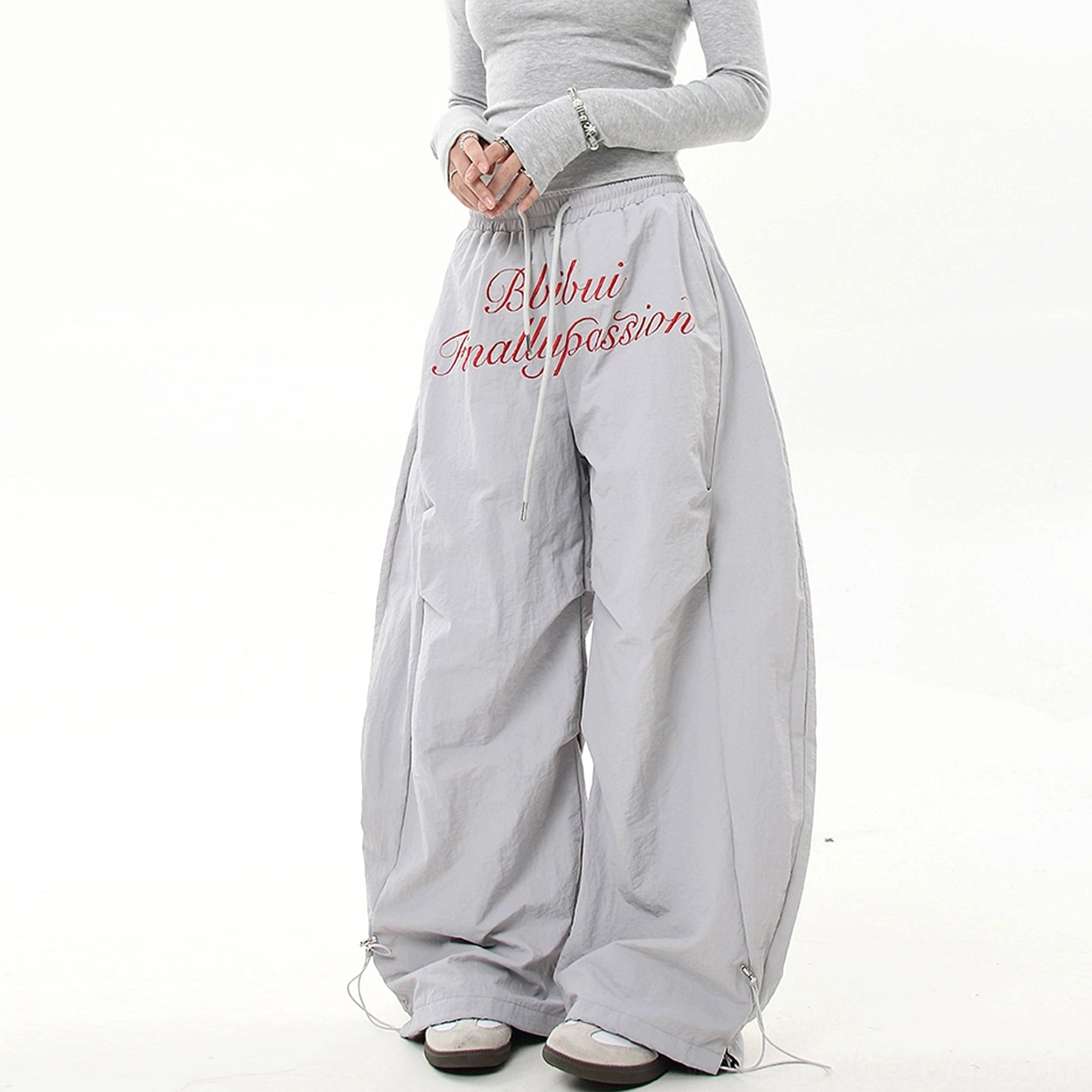 Gray Scripted Devotion oversized parachute cargo pants featuring relaxed streetwear proportions, technical fabric and adjustable bungee hems