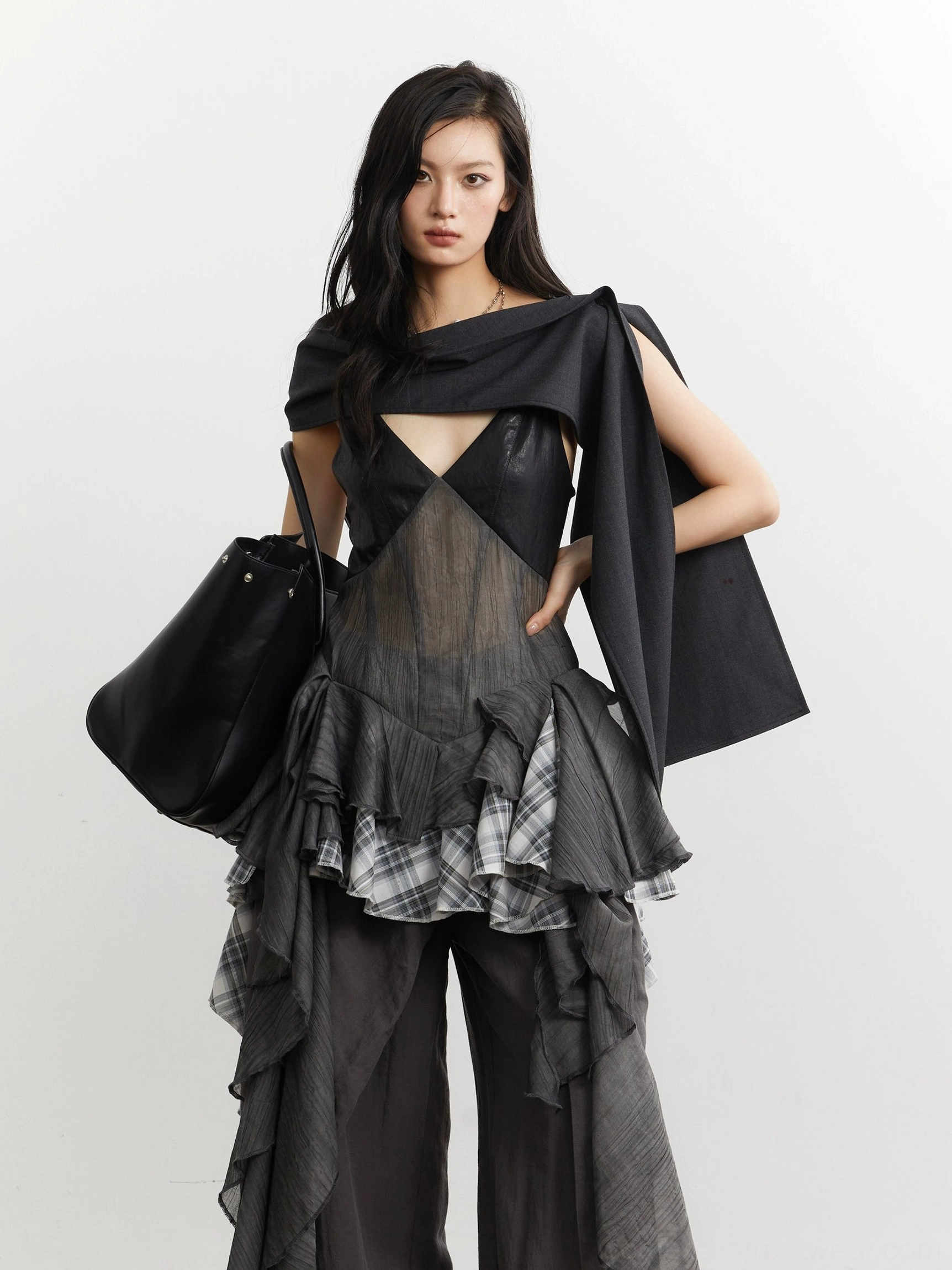 Gray sheer mesh deconstructed camisole top with deep V neckline and plaid ruffle cascade styled with a black tote bag