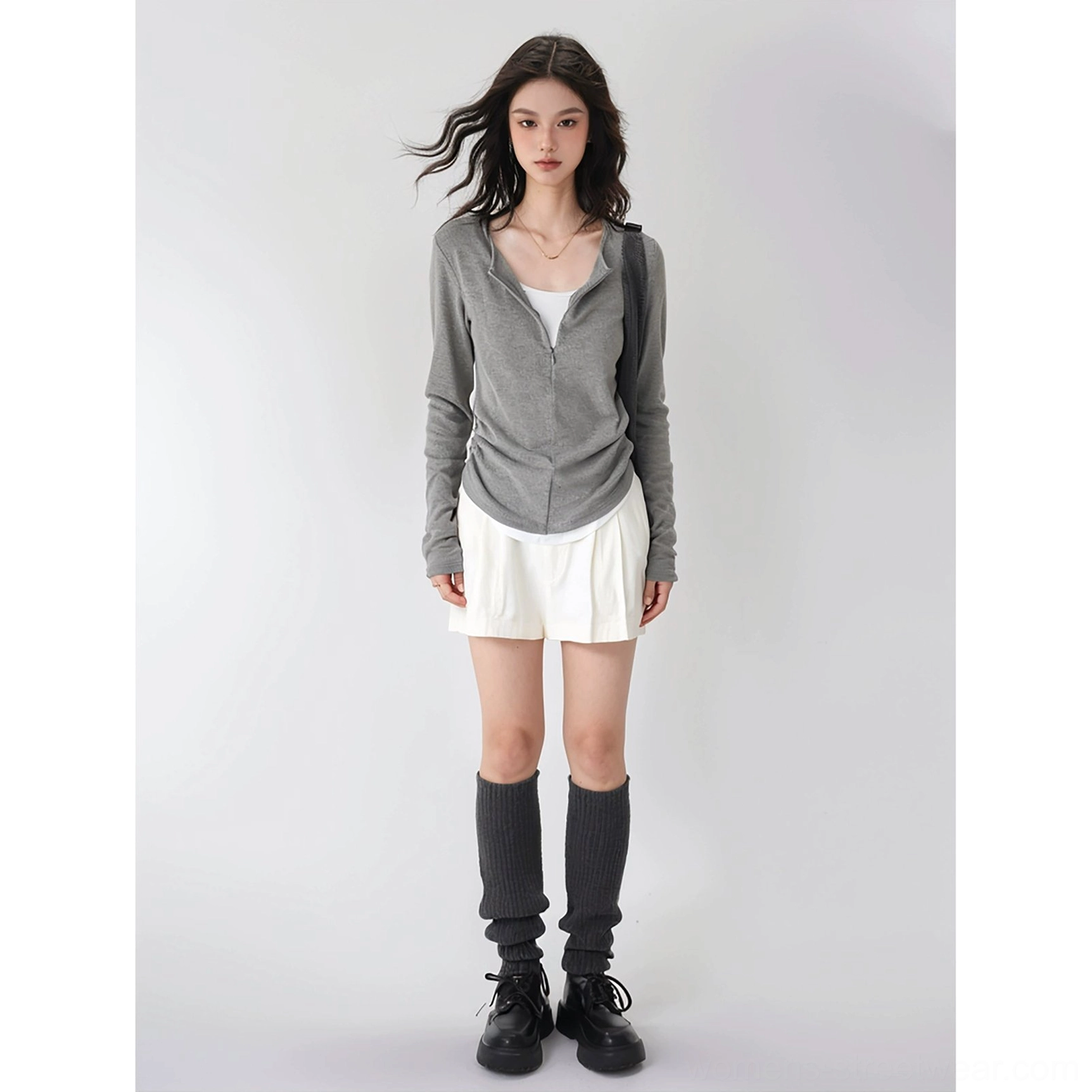 Gray slim-fit half-zip stand collar ribbed knit top with layered hem styled in modern Seoul street fashion