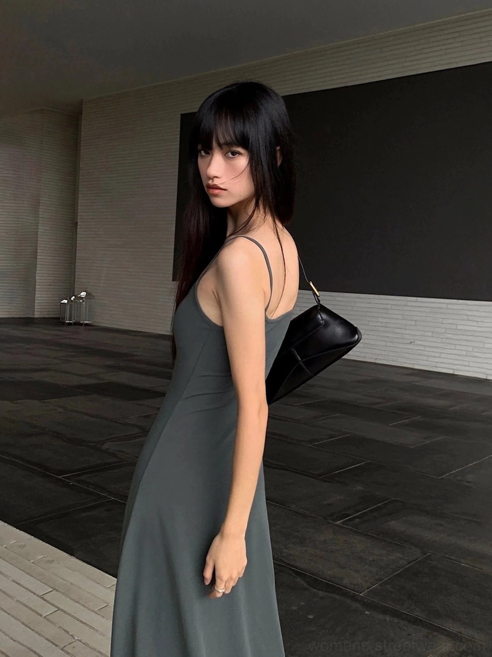 Gray spaghetti strap maxi dress shown from the back side with an open back and soft stretchy fabric