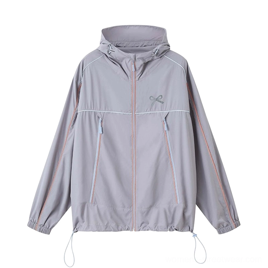 Gray sporty hooded windbreaker jacket product view with half-zip front, contrast piping, chest bow embroidery, and adjustable drawstring hem