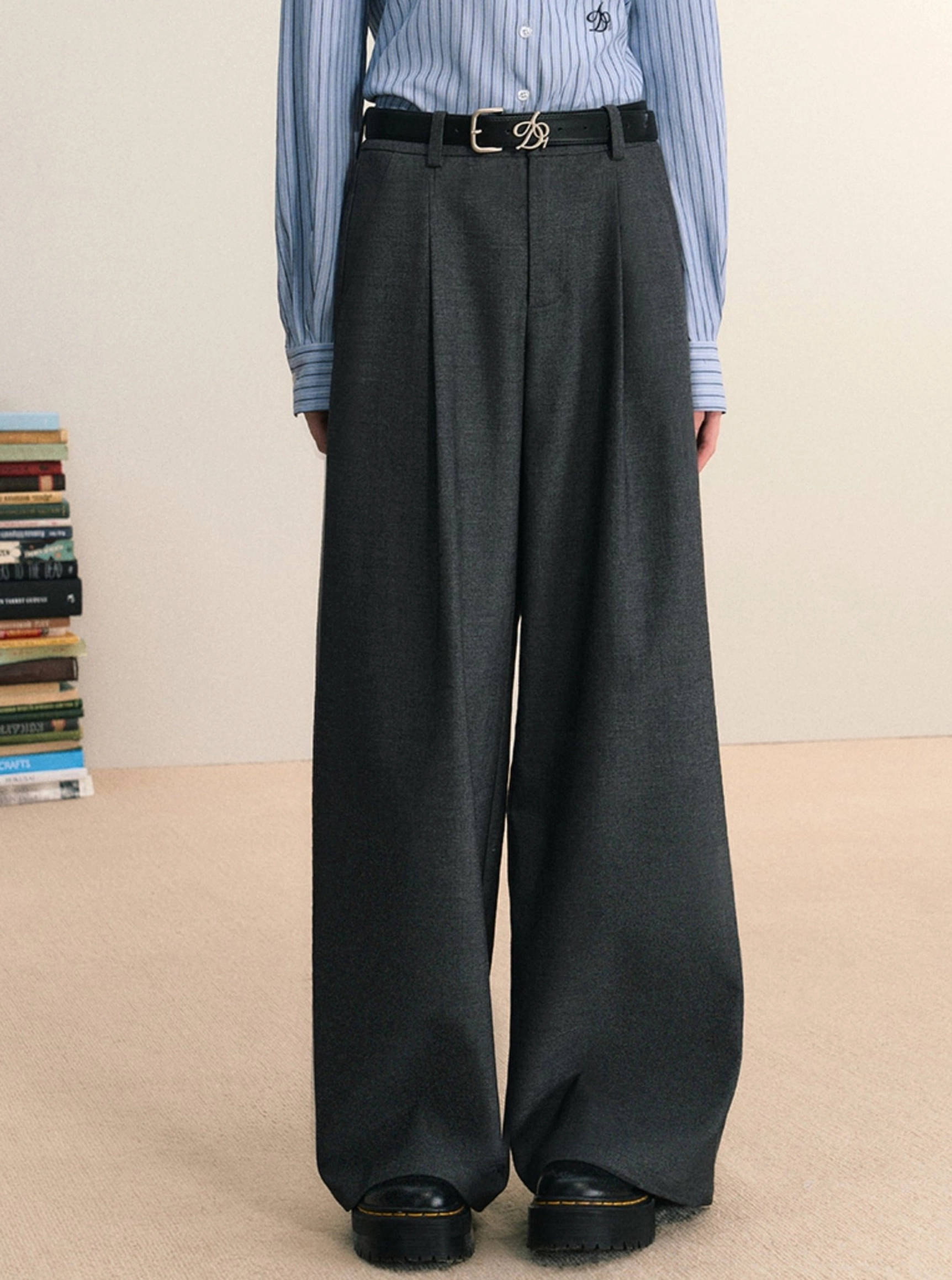 Gray tailored pleated wide-leg trousers shown in a full-body front styling with a blue striped shirt and black belt