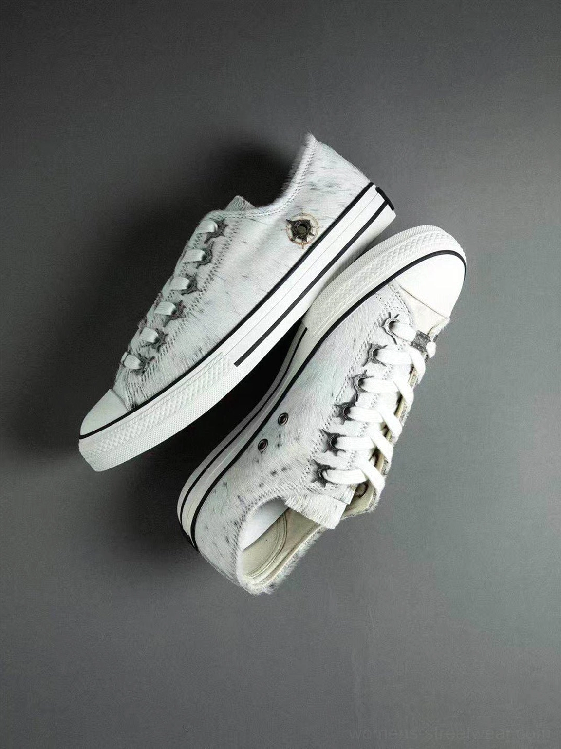 Pair of gray white marbled cowhide low-top sneakers shown from above with contrast laces and heel logo detail