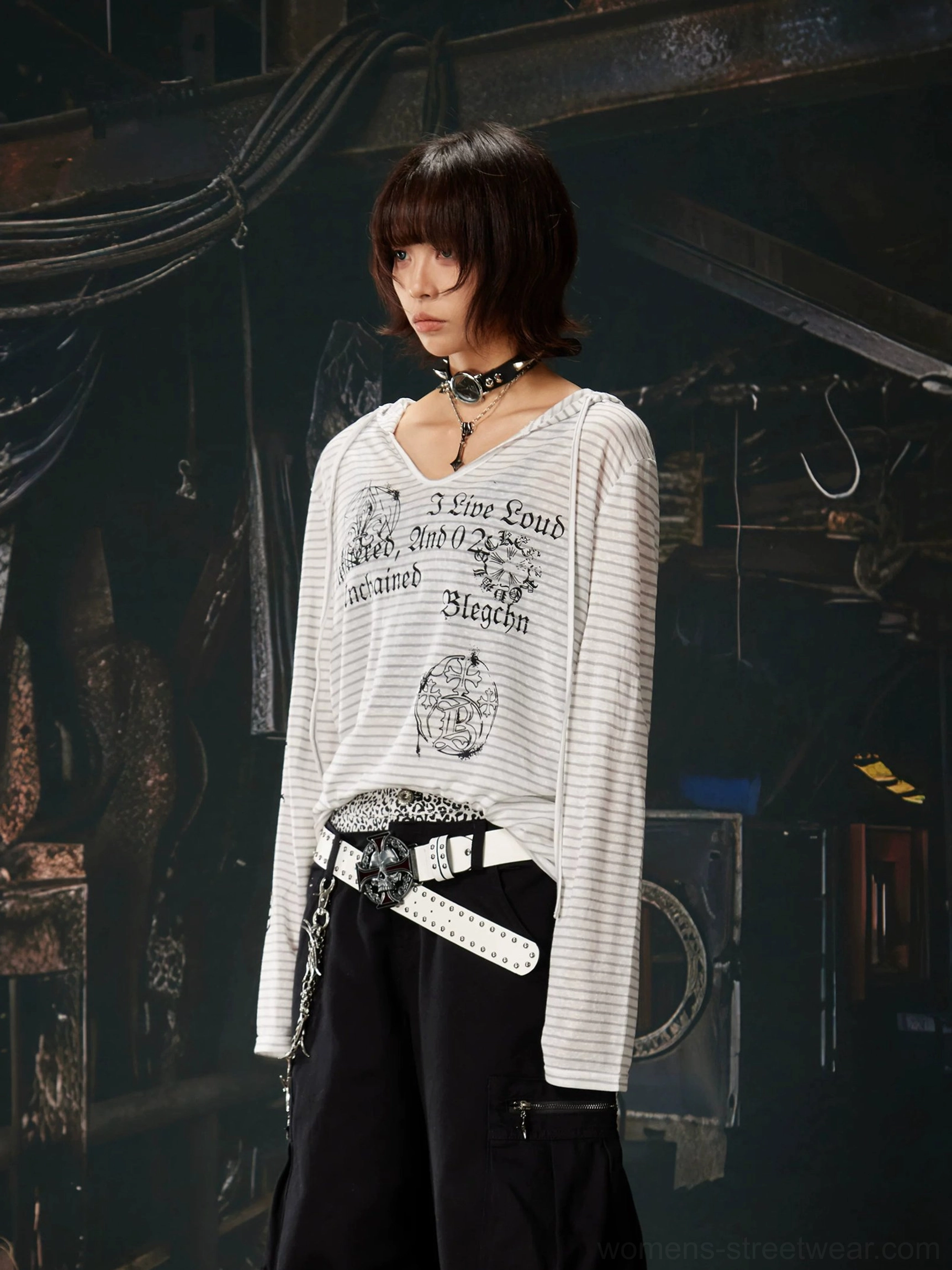 Front view of a gray and white striped gothic long sleeve hooded top with a relaxed streetwear fit, styled with a white belt and black cargo pants