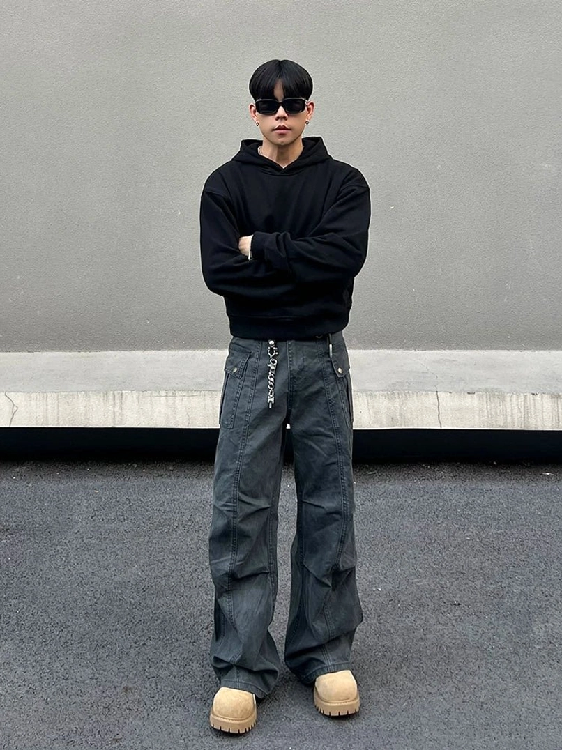 Full front view of gray wide-leg streetwear cargo pants with embroidered drawstring waistband and relaxed urban silhouette