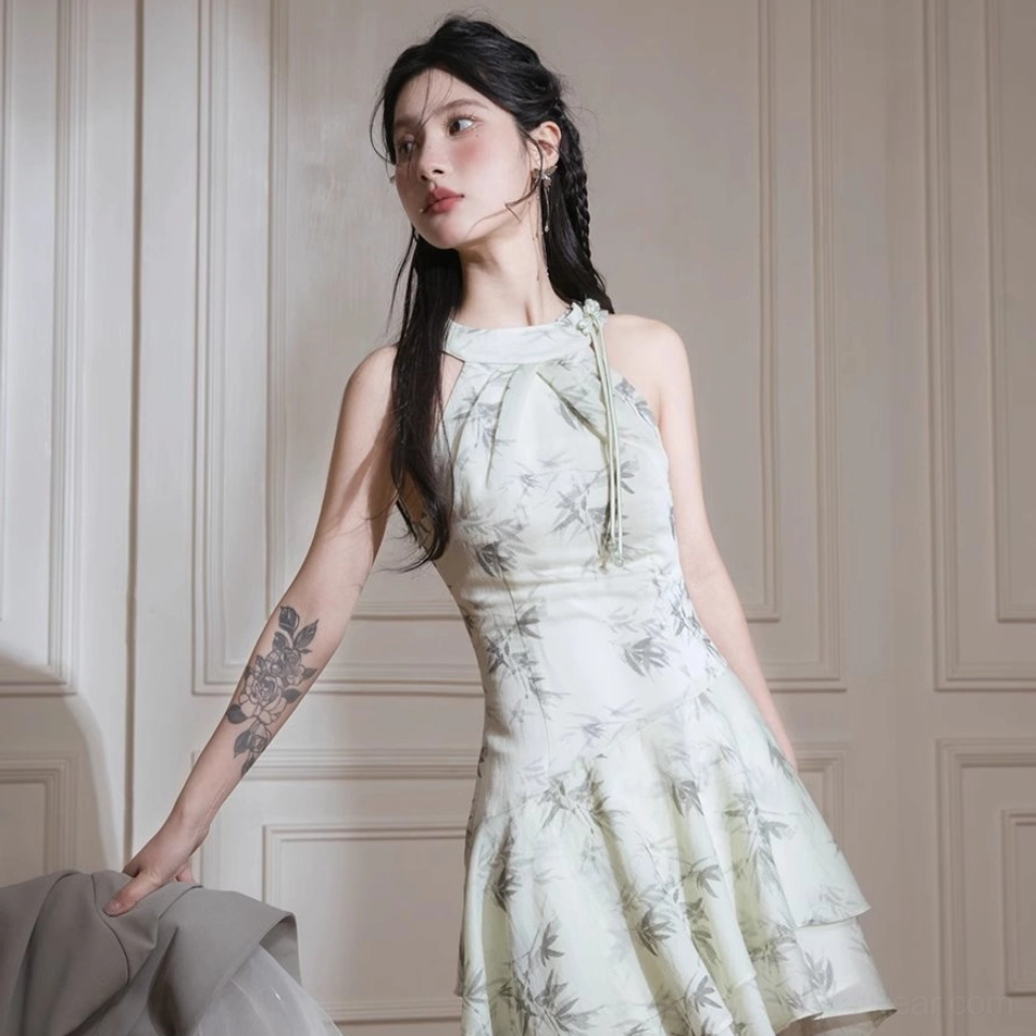 Green bamboo leaf print halter dress with airy chiffon texture and contemporary asymmetric midi length