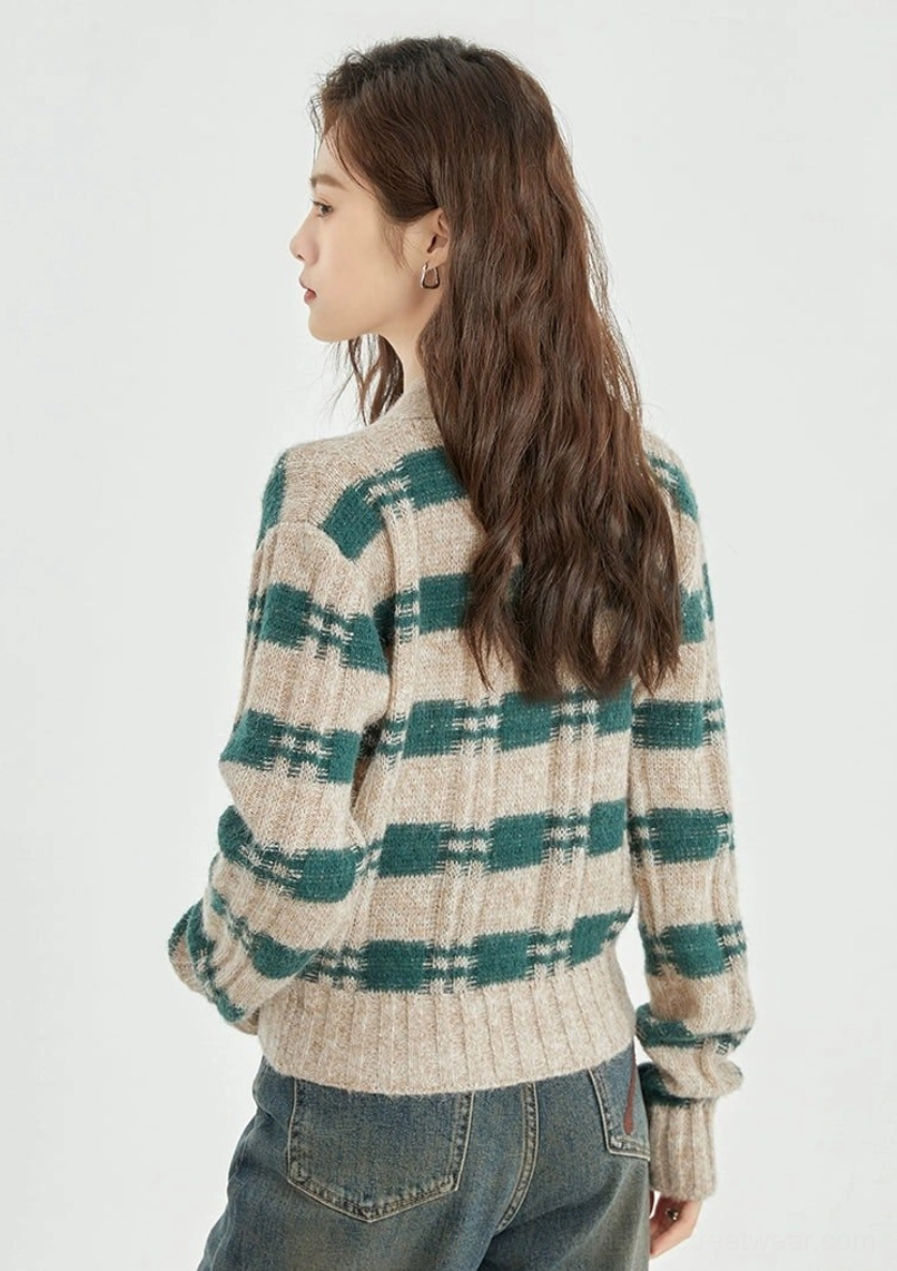 Right back view of green beige plaid cropped knit cardigan paired with high waisted blue jeans