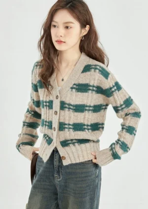 Three quarter front view of green beige plaid cropped knit cardigan with V neck and button front