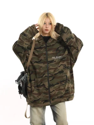 Green camo zip-up fleece jacket with oversized silhouette styled with washed wide-leg jeans and a vintage crossbody backpack