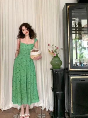 Full body view of green floral long dress with thin straps square neckline fitted waist and elegant floor length skirt