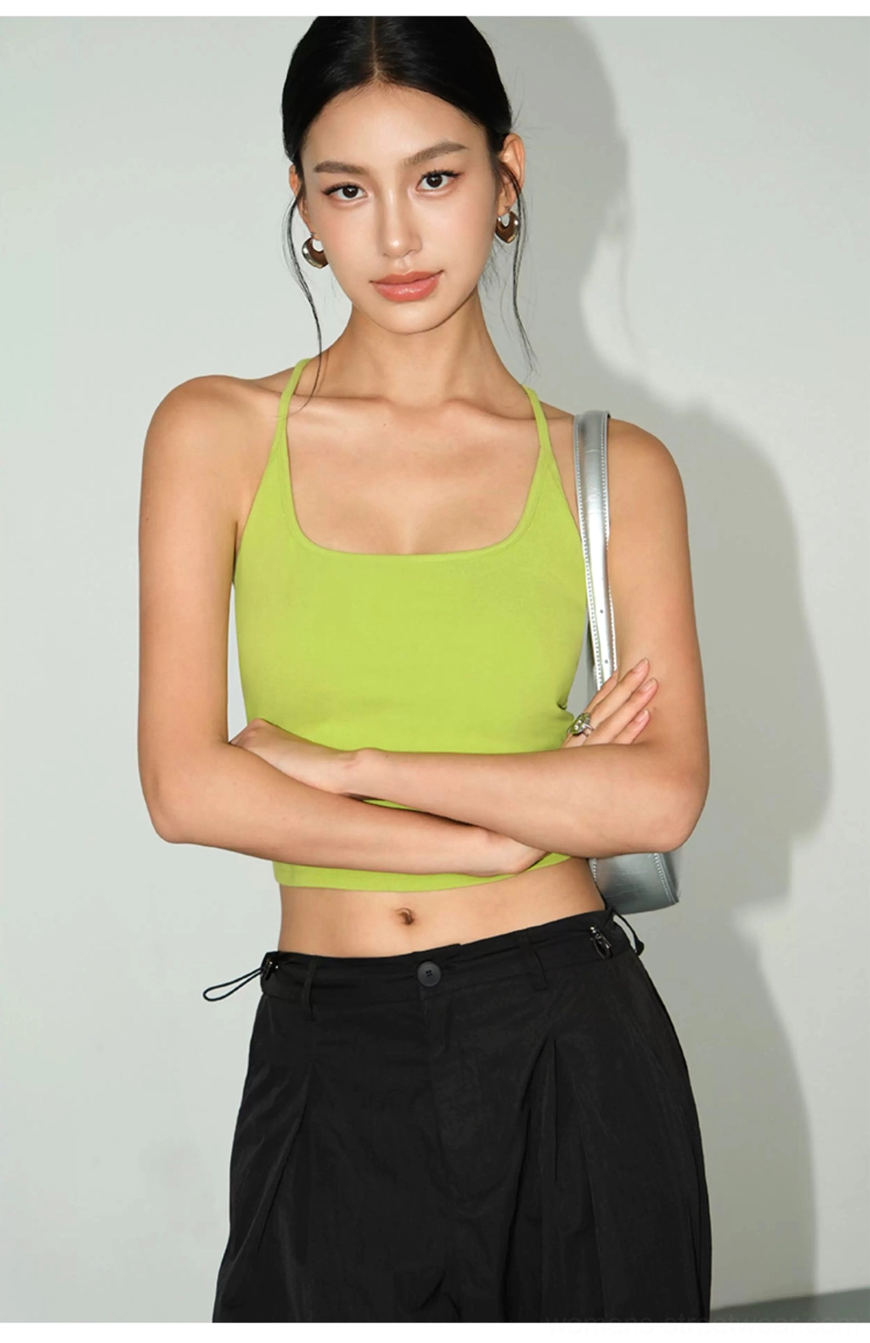 Green Fruit fitted square neck racerback knit crop tank paired with black cargo pants and silver bag