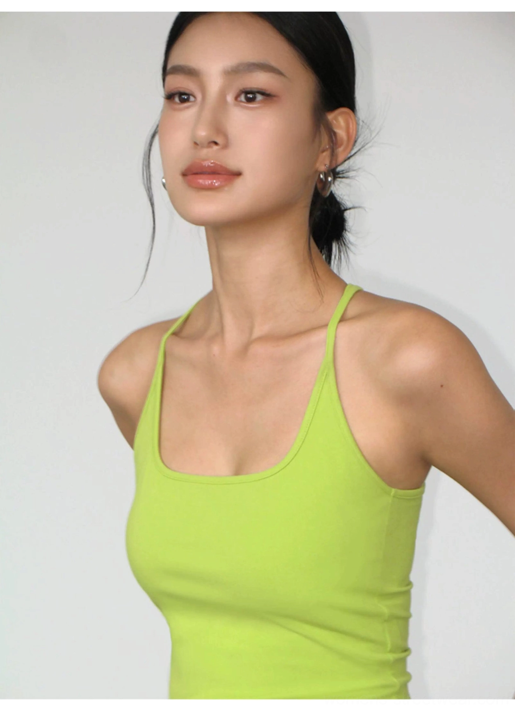 Close-up of Green Fruit square neckline and slim straps on fitted knit crop tank for women