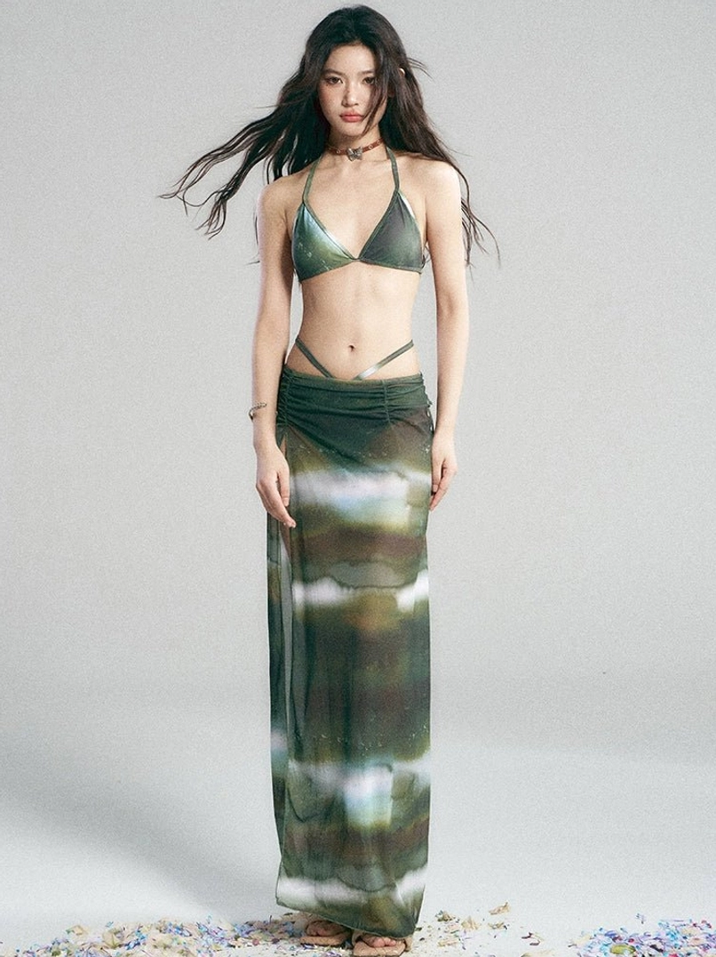 Front view of green galaxy print bikini and maxi skirt set with ruched waist and colorful watercolor cosmic pattern