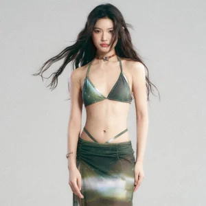 Green galaxy print bikini set with sheer maxi skirt, halter triangle top, low rise string bottoms, and ruched waist