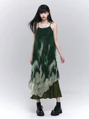 Front view of a green gradient tie-dye maxi slip dress with square neckline, flowing layered silhouette, asymmetrical hem, and black platform boots