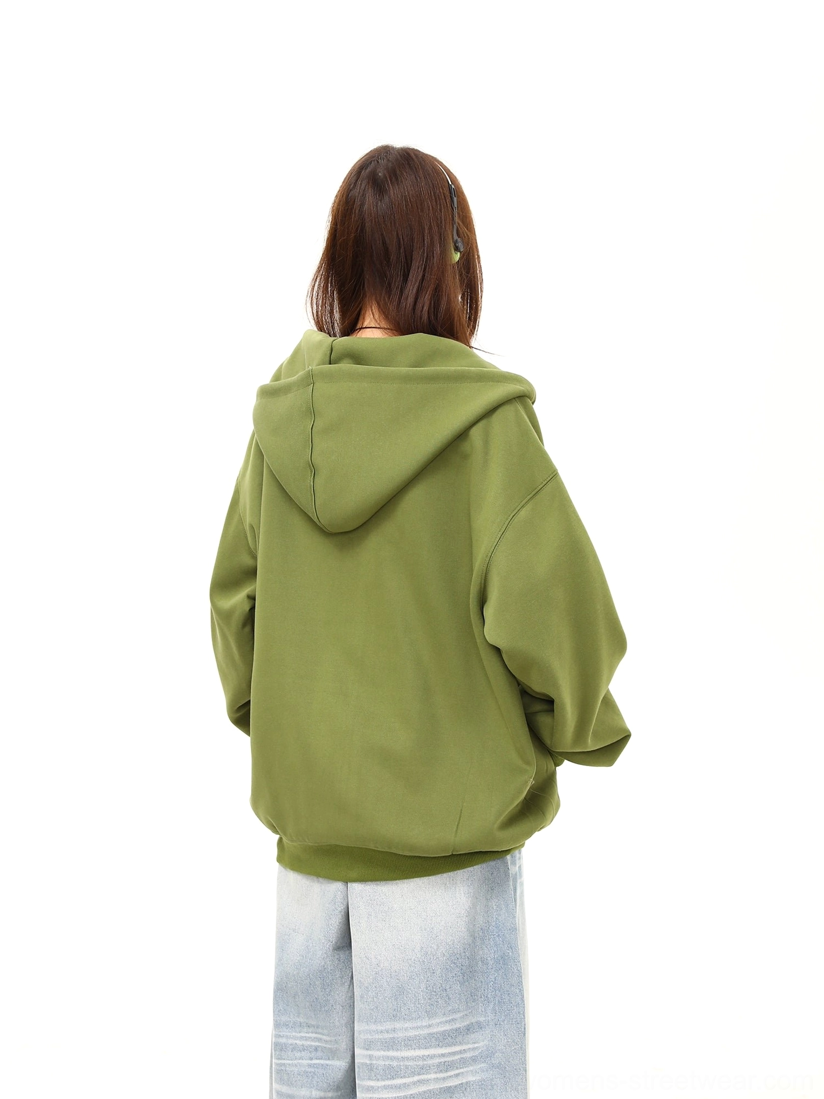 Back view of a green oversized hooded zip-up hoodie showing the clean plain back, loose sleeves, and soft fleece-like texture
