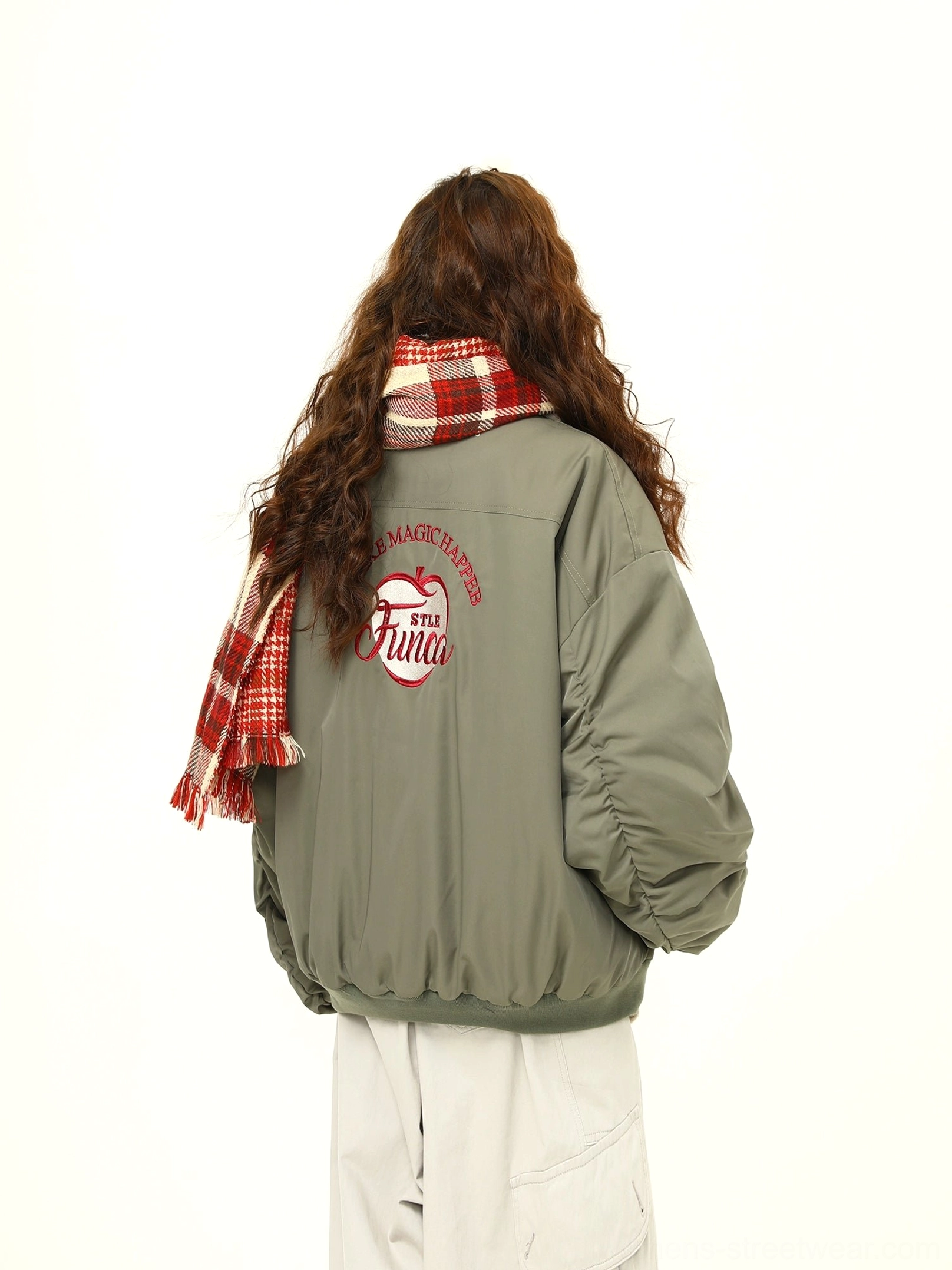 Back view of oversized green varsity bomber jacket with embroidered back logo and fleece collar