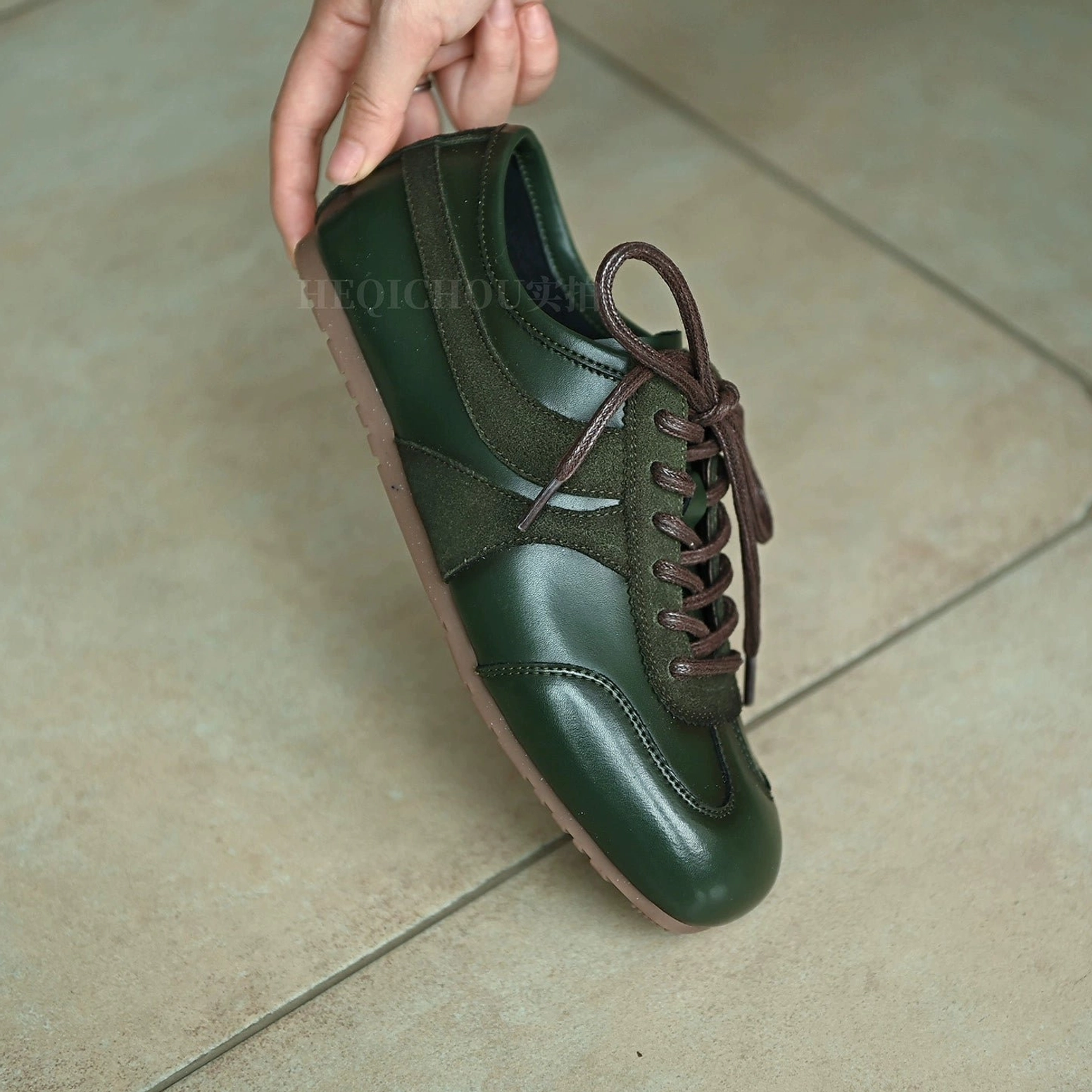 Green retro leather and suede streetwear sneakers with low-top lace-up construction, tonal panel design, and vintage-inspired everyday styling