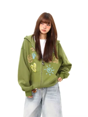Front view of a green solar doodle washed zip-up hoodie with colorful hand-drawn graffiti graphics, oversized hood, and relaxed Korean streetwear styling