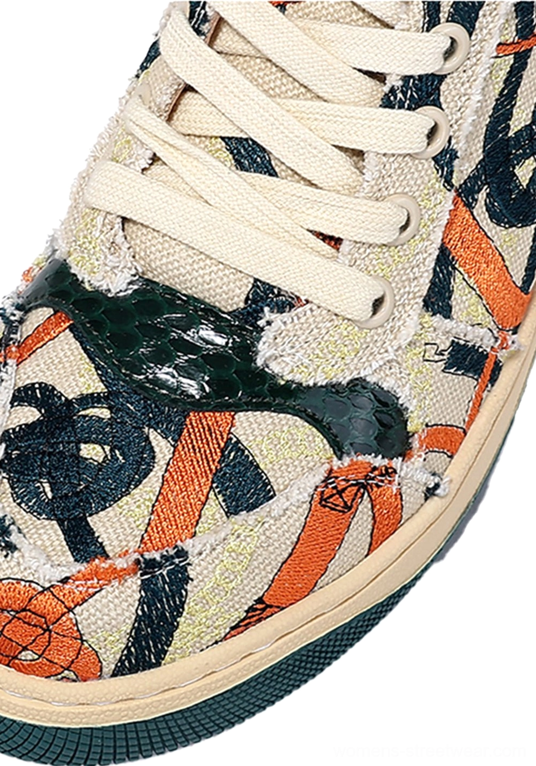 Close-up of green sole graffiti canvas low-top sneaker showing canvas texture laces stitching and multicolor graphic print