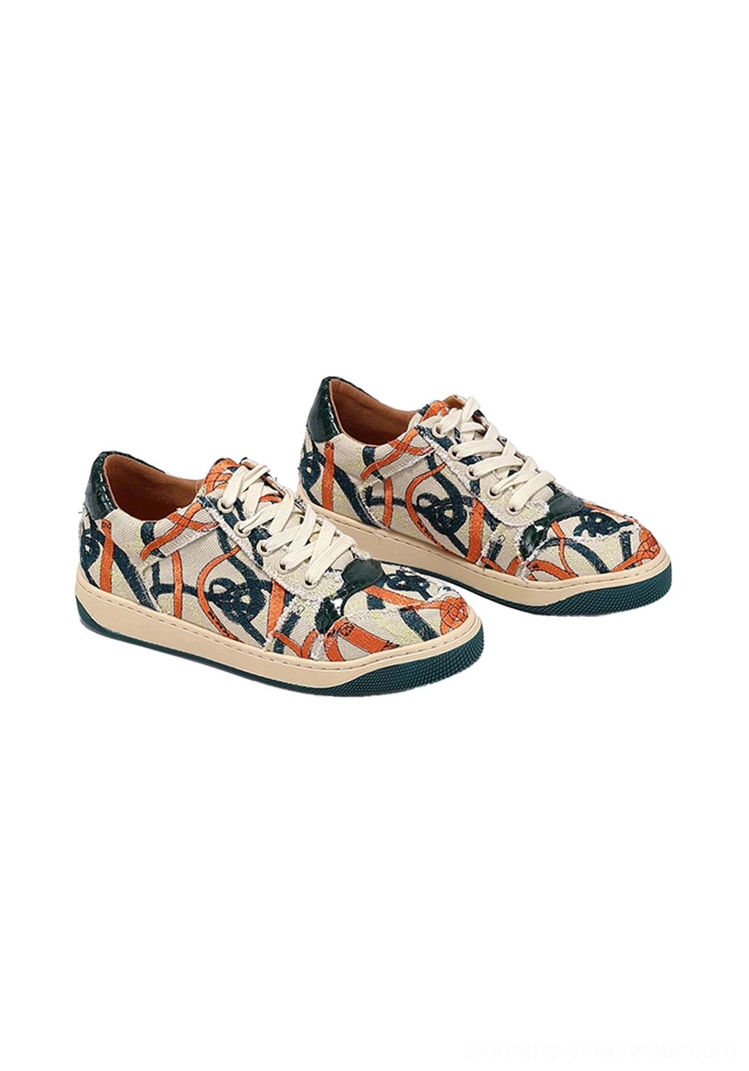 Green sole graffiti canvas low-top sneakers in oblique front product view highlighting colorful street art print and toe shape