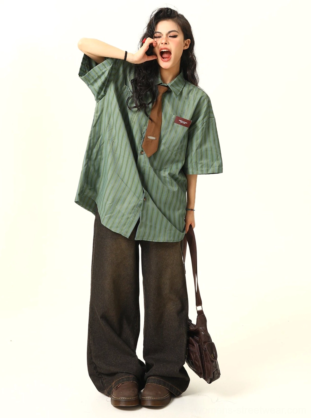 Green striped oversized shirt with short sleeves and brown tie styled with dark brown wide leg pants and leather shoes