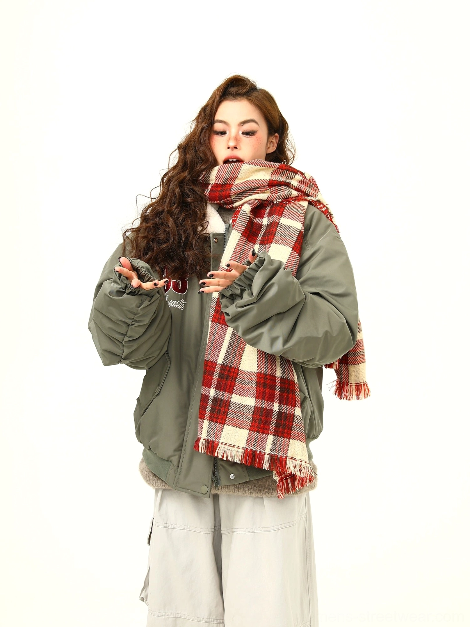 Close front view of army green varsity patch bomber jacket with number embroidery and snap buttons