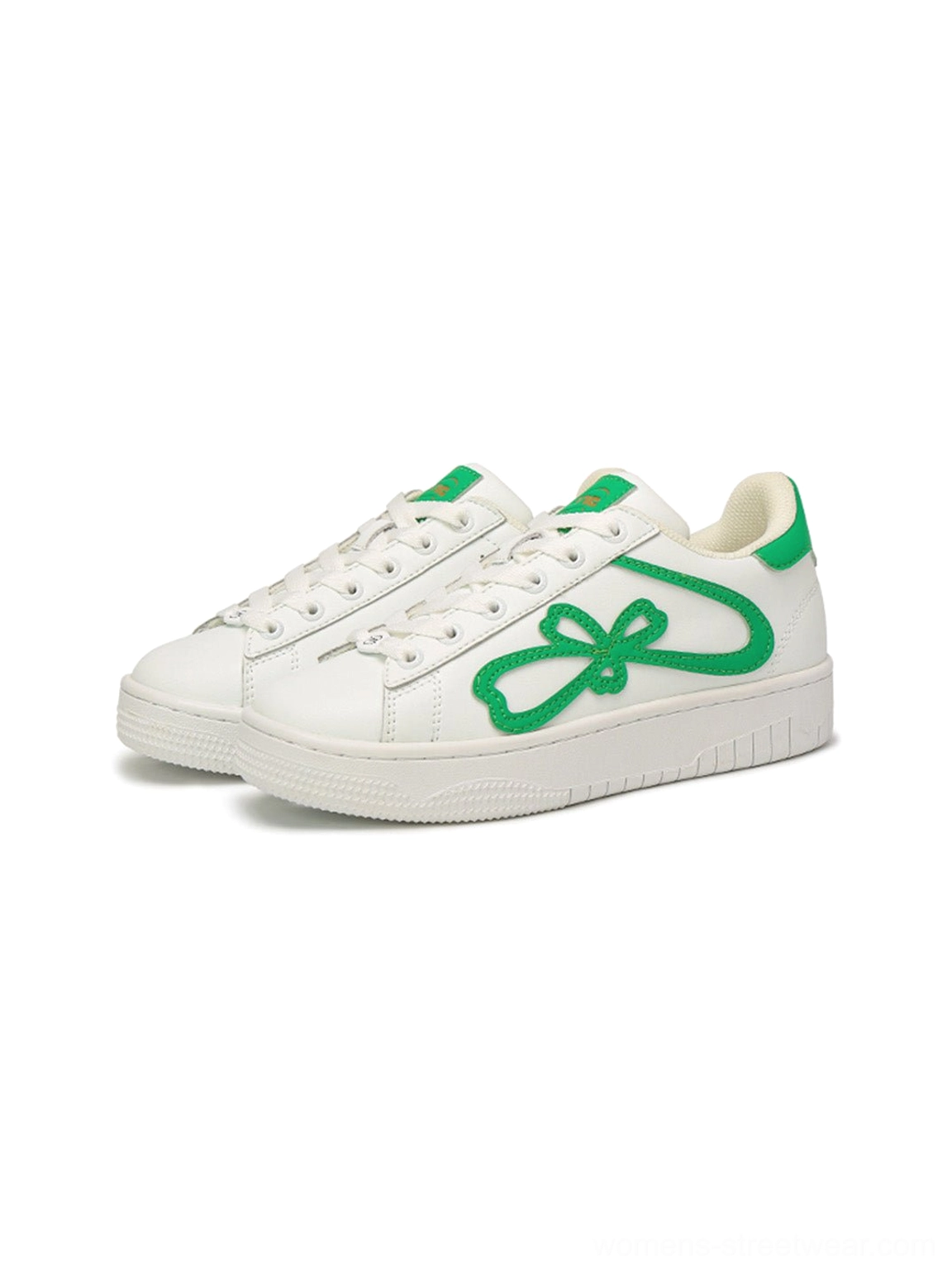 Pair of green and white lucky clover chunky platform sneakers shown from a front side angle
