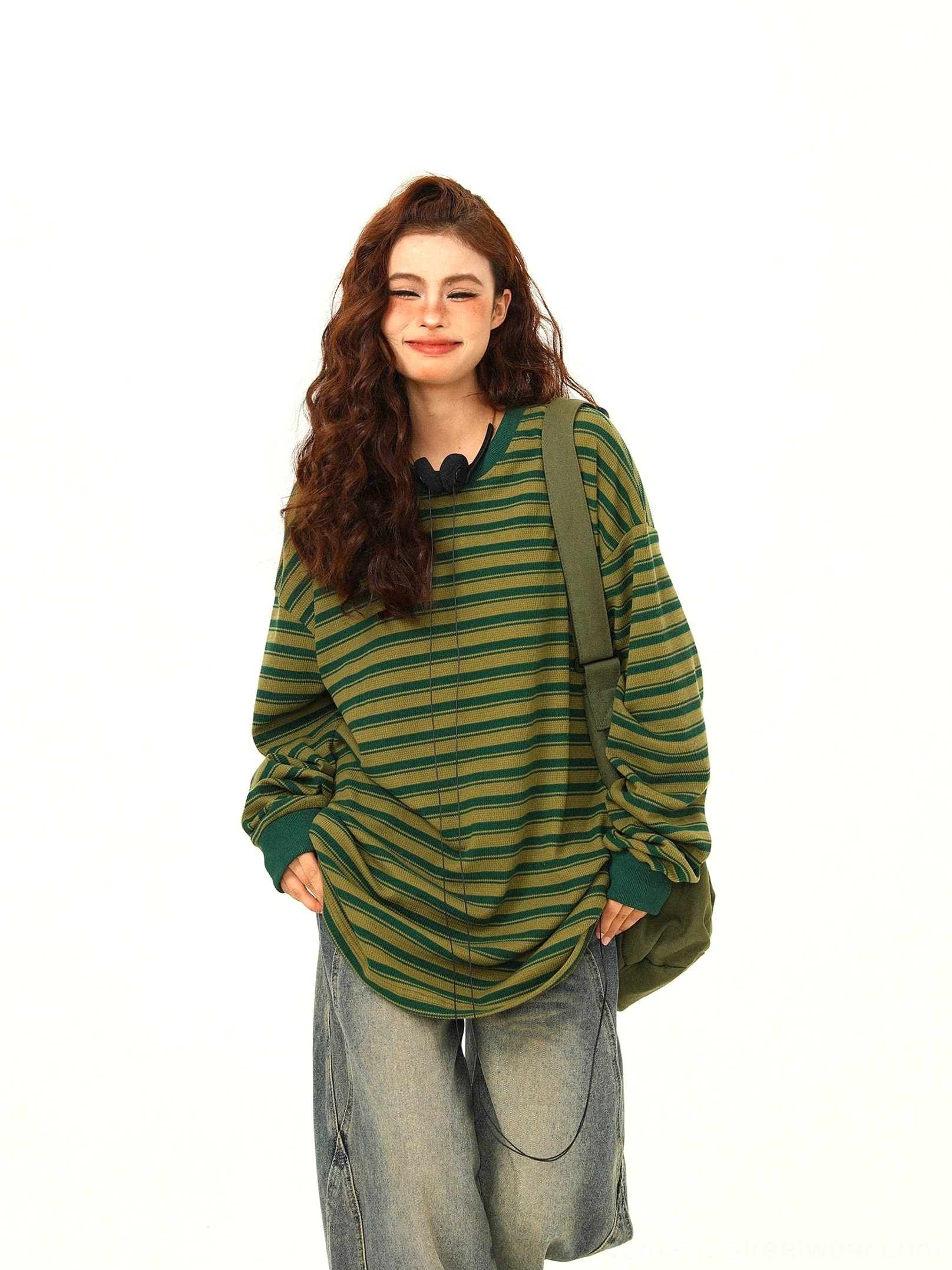 Green and yellow striped oversized drawstring hem tee paired with jeans and olive crossbody bag for Seoul streetwear