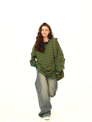 Green and yellow striped oversized drawstring long sleeve streetwear tee front view styled with wide leg jeans and sneakers