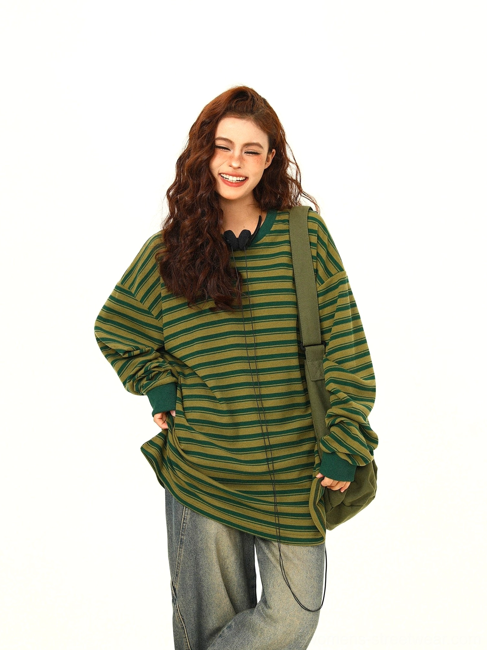 Green and yellow striped oversized streetwear tee close view showing relaxed dropped shoulder silhouette and crew neckline