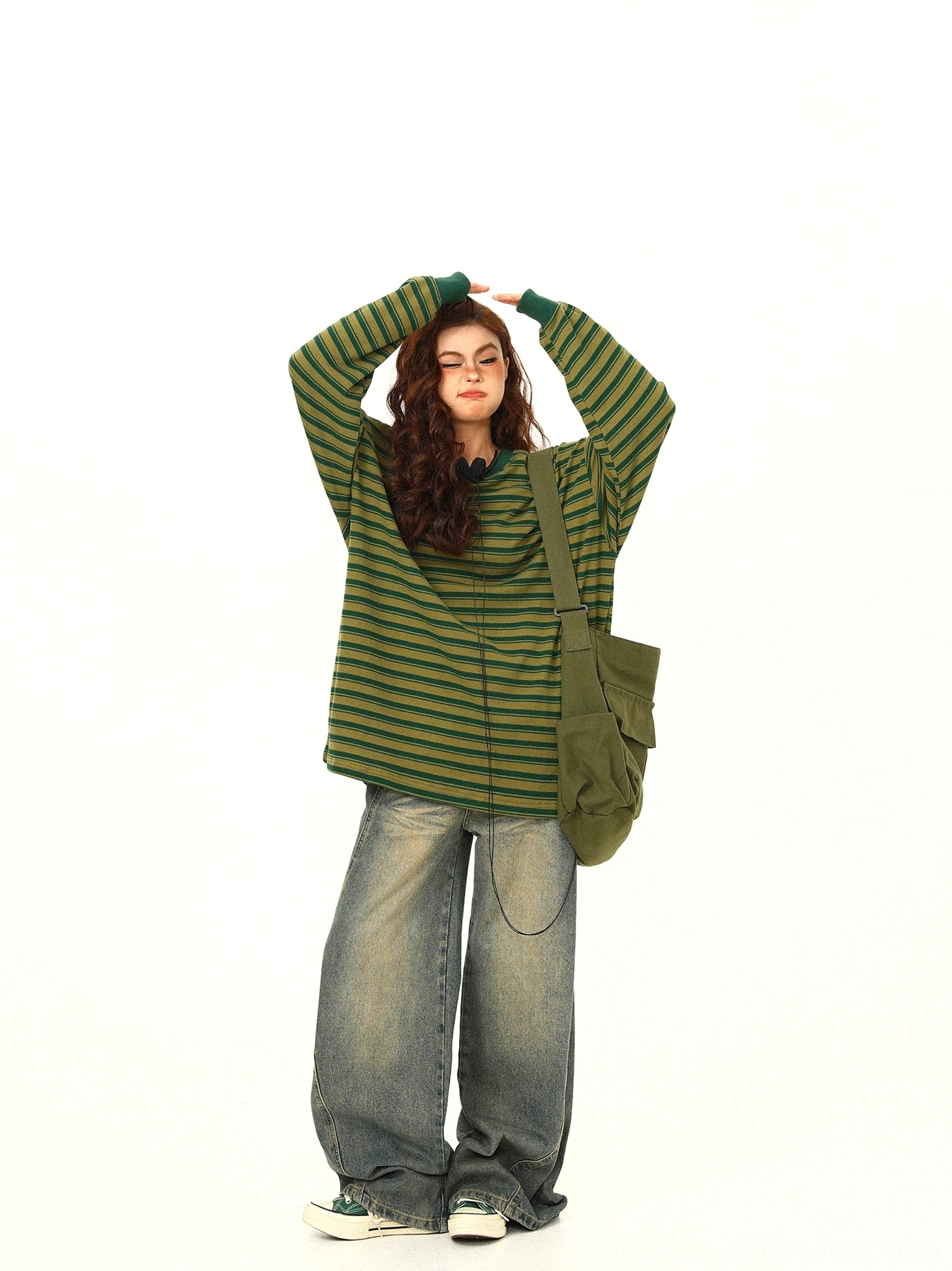 Side front view of green yellow vertical striped oversized cotton long sleeve tee with dropped shoulders